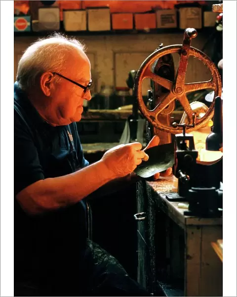 Edwin Macklow, first generation cobbler at work in his shop