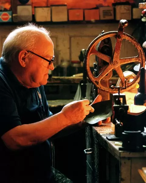 Edwin Macklow, first generation cobbler at work in his shop