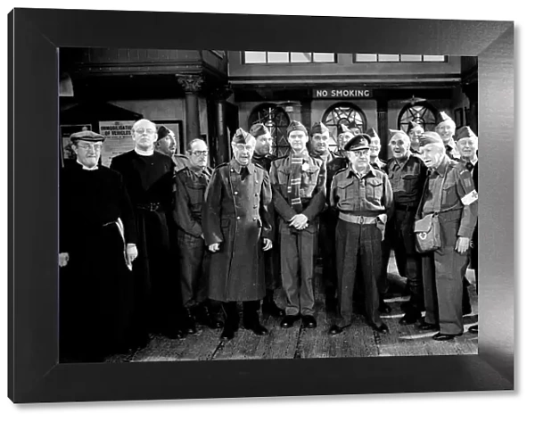 Stars of the popular wartime comedy television programme Dads Army toast pose for a group