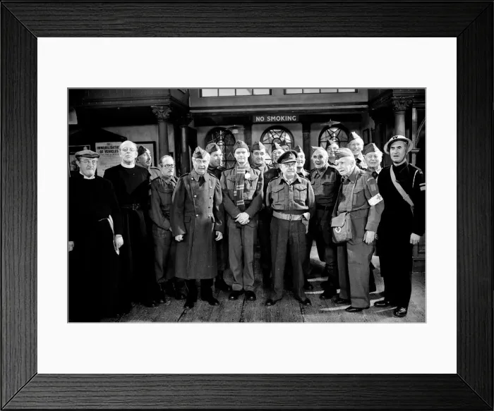 Framed Print : Stars of the popular wartime comedy television programme Dads Army toast pose for a group Framed Print : Stars of the popular wartime comedy television programme Dads Army toast pose for a group