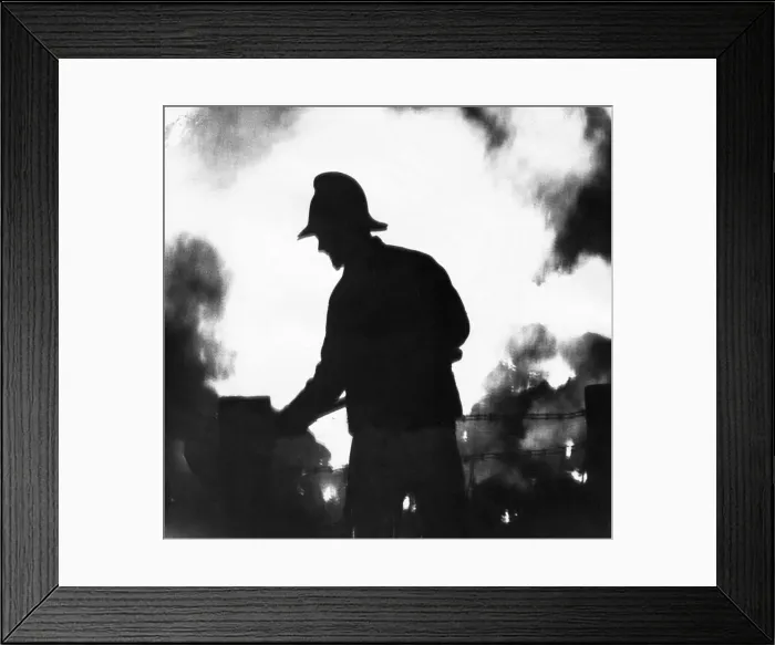 Framed Print : A silhouette of fireman fighting the blaze