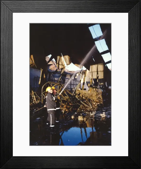 Framed Print : Firefighters get the warehouse fire under control