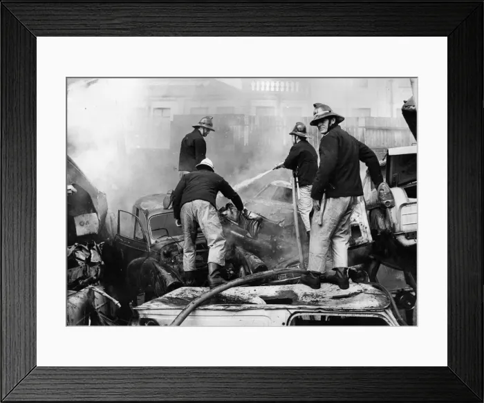 Framed Print : Firefighters scrambled about on piles of old cards to tackle a fire at Benfield Vehicle Framed Print : Firefighters scrambled about on piles of old cards to tackle a fire at Benfield Vehicle