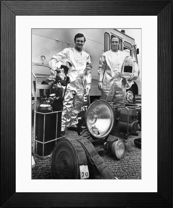 Framed Print : Firefighters David Edwards, left, and Ken Bailey dressed in heat proof suits with