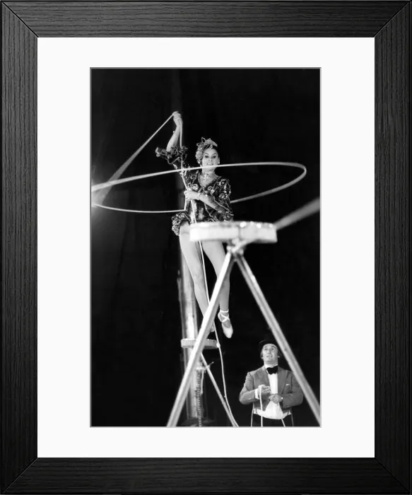 Framed Print : A performer rope twirling as they walk on the high wire Framed Print : A performer rope twirling as they walk on the high wire