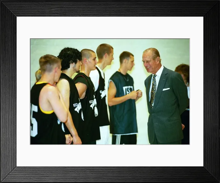 Framed Print : Prince Philip, Duke of Edinburgh, chats to the basketball players at the Washington
