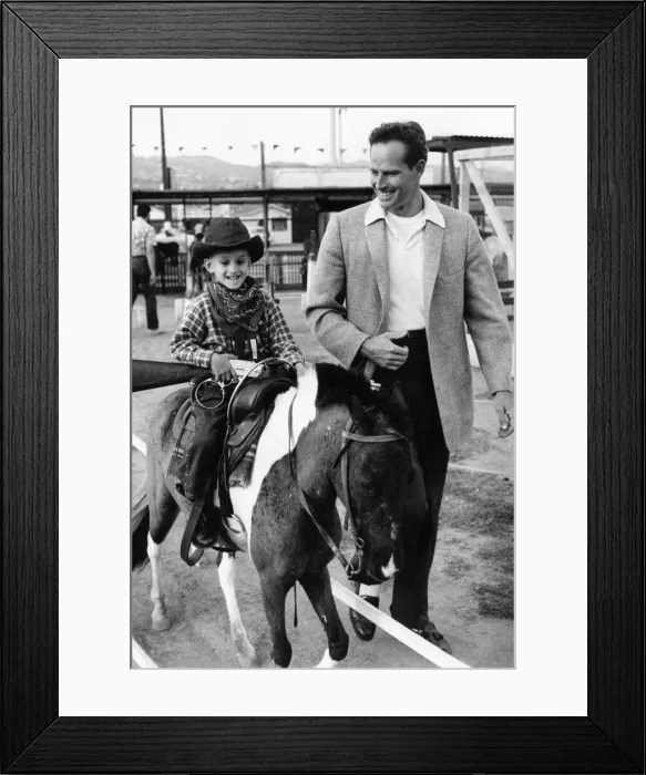 Framed Print : Charlton Heston with a young boy on a horse