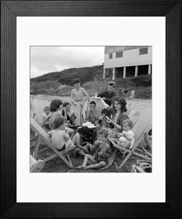 Framed Print : Mrs Mavis Graham and her 12 children seen here having a picnic beside the sea at Bigbury Framed Print : Mrs Mavis Graham and her 12 children seen here having a picnic beside the sea at Bigbury