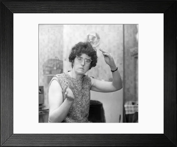 Framed Print : Humour: Woman wearing glasses gestures with her hands. December 1969 Z12083 Framed Print : Humour: Woman wearing glasses gestures with her hands. December 1969 Z12083