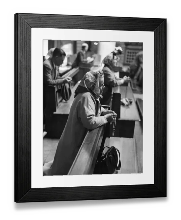 Framed Print : Women and girls with shopping bags who stopped for a few moments to pray