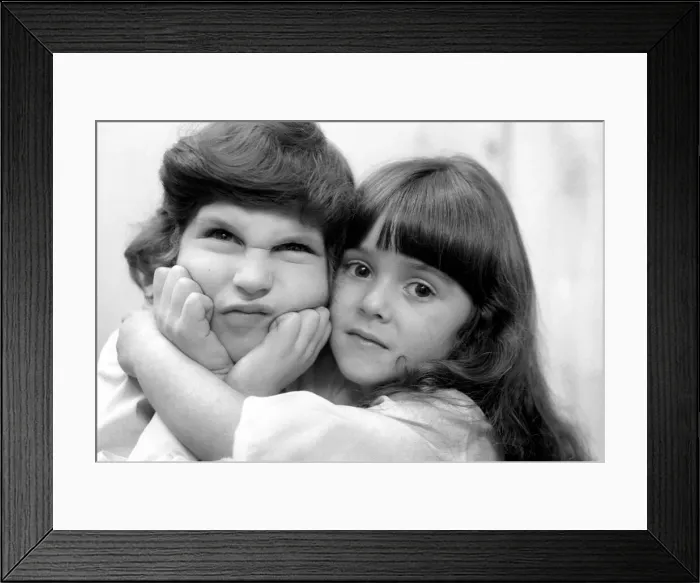 Framed Print : Leap year spells trouble for single males. Unhappy boy gets kisses and cuddles from girls Framed Print : Leap year spells trouble for single males. Unhappy boy gets kisses and cuddles from girls