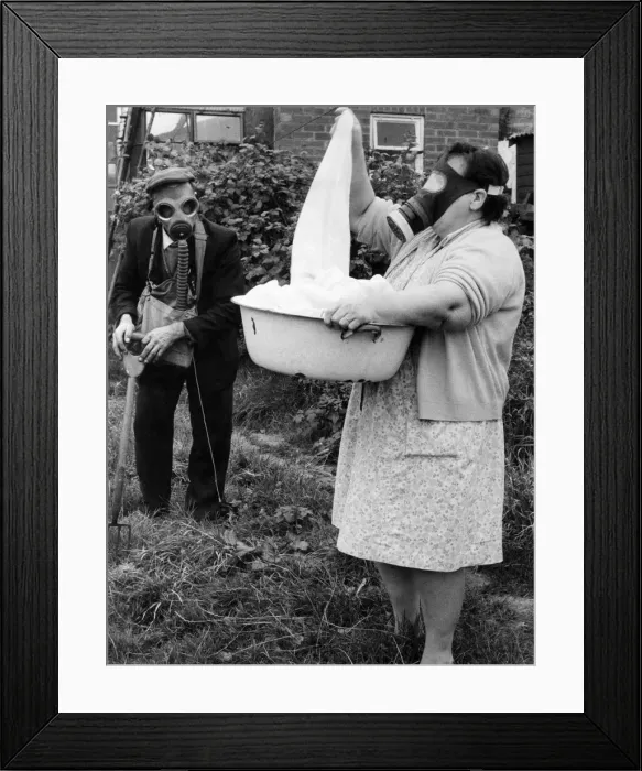 Framed Print : Mr. and Mrs. Wicks wearing their gas masks in the garden. November 1971 P023493 Framed Print : Mr. and Mrs. Wicks wearing their gas masks in the garden. November 1971 P023493