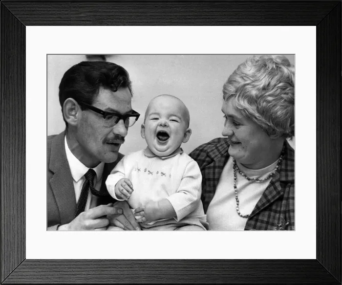 Framed Print : Children - Babies. Chuckles from miracle baby Shaun as he sits with his mother and father