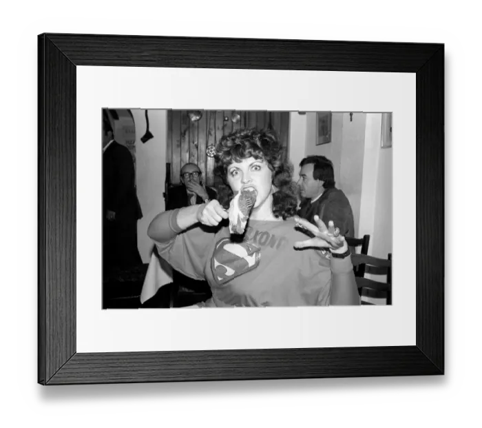 Framed Print : Queen: Kong: A woman sitting at a table with a large plate of food in a restaurant