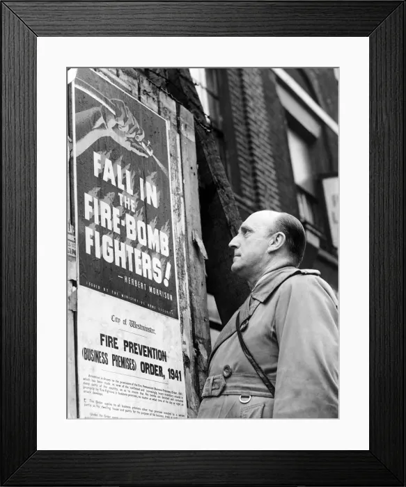 Framed Print : How to join the firefighters. Man looking at poster encouraging men to recruit Framed Print : How to join the firefighters. Man looking at poster encouraging men to recruit