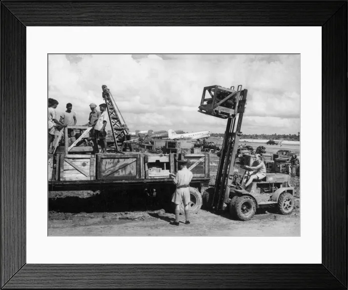 Framed Print : A hydraulic lifter unloads heavy mechnaical parts such as aircraft engines from Framed Print : A hydraulic lifter unloads heavy mechnaical parts such as aircraft engines from