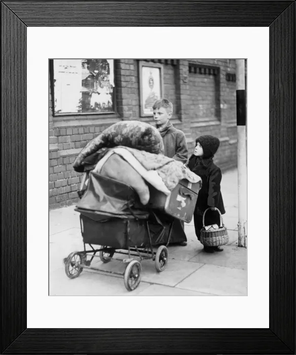 Framed Print : Homeless children with a pram of possessions. 22nd November 1940 Framed Print : Homeless children with a pram of possessions. 22nd November 1940