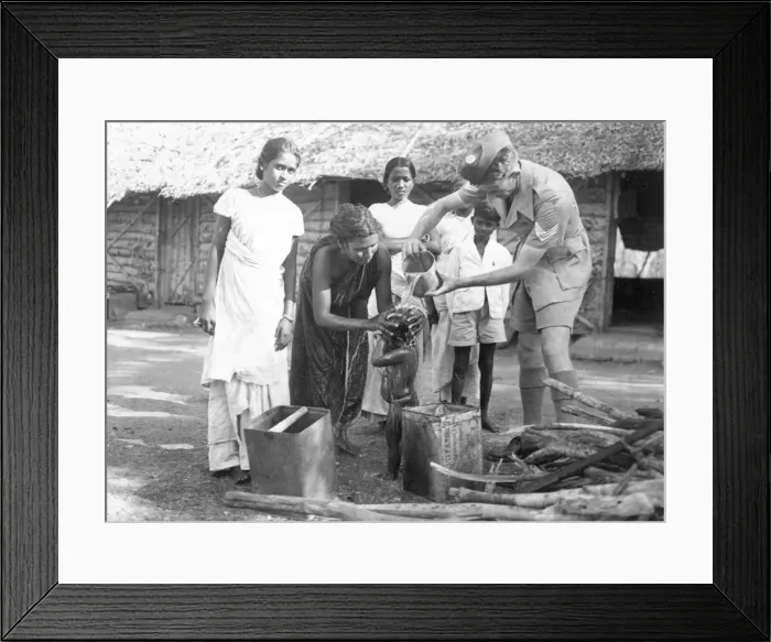 Framed Print : Sergeant Ferris of the Royal Air Force helping to wash the hair of a young child during Framed Print : Sergeant Ferris of the Royal Air Force helping to wash the hair of a young child during