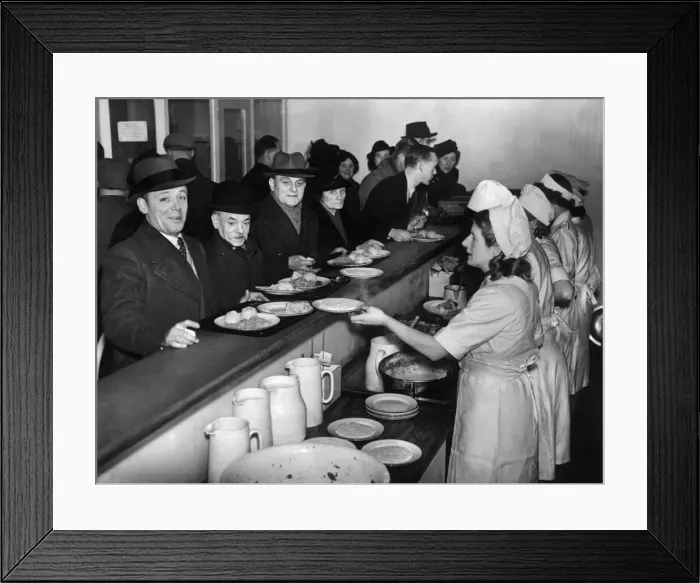 Framed Print : Customers filing past the serving counter at the communal feeding centre