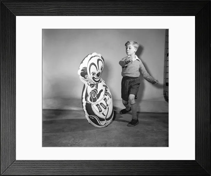 Framed Print : Boy boxing a toy punch bag. December 1953 D7218 Framed Print : Boy boxing a toy punch bag. December 1953 D7218