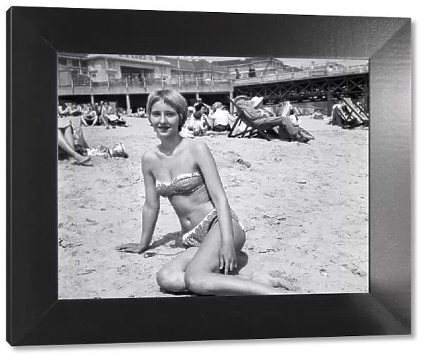 Woman relaxing on the beach at Bournemouth during a hot summer