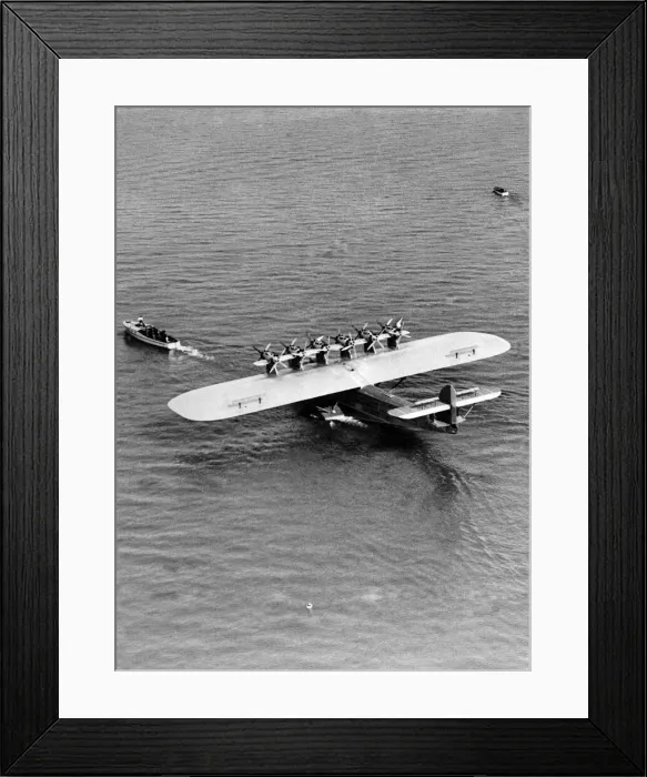 Framed Print : A giant Dormier Do-X seaplane being towed into position before starting on its Framed Print : A giant Dormier Do-X seaplane being towed into position before starting on its