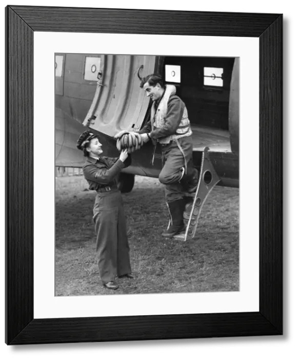 Framed Print : World War II Women. A pilot arriving from overseas to a Transport Command station handing Framed Print : World War II Women. A pilot arriving from overseas to a Transport Command station handing