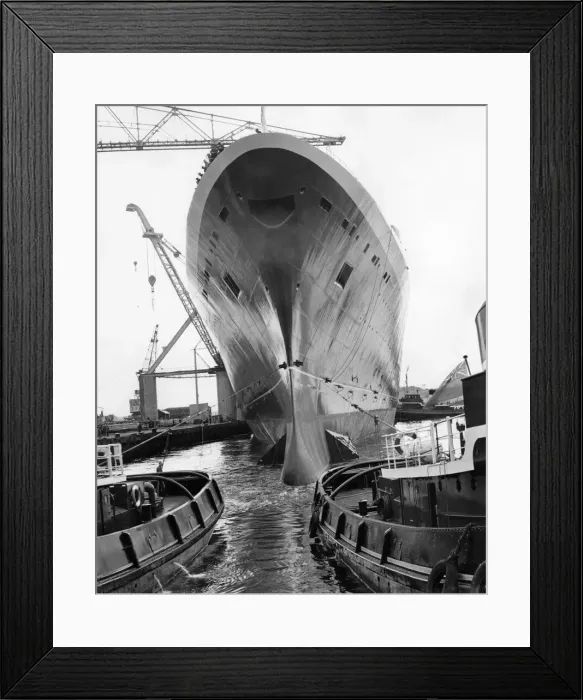 Framed Print : The Liner Queen Elizabeth II, towering over the tugs as she moves into the fitting out Framed Print : The Liner Queen Elizabeth II, towering over the tugs as she moves into the fitting out