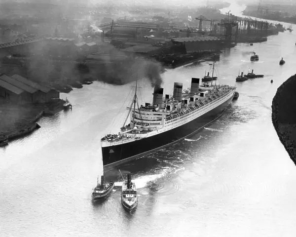The Cunard White Star Liner the RMS Queen Mary makes her way down the River Clyde to