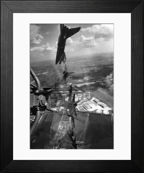 Framed Print : A Red Arrows display Gnat trainers flying in formation over their base at Chivenor