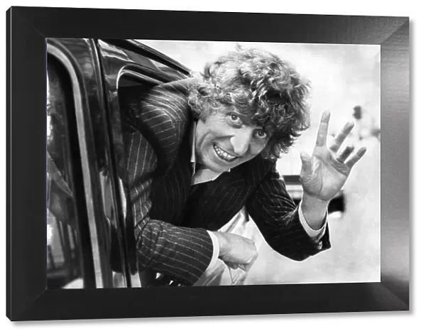 English actor Tom Baker waving from the back of a taxi. October 1980 P003678