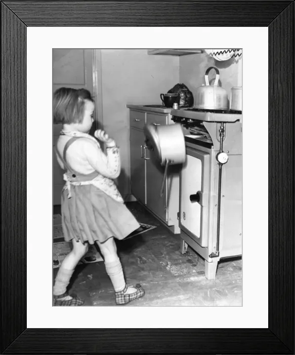Framed Print : This young girl wants to cook like mother, however dangers lurk everywhere for Framed Print : This young girl wants to cook like mother, however dangers lurk everywhere for