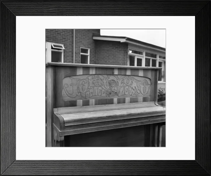 Framed Print : Close up of the carving on the John Lennon piano which says Joan and Yoko, Pease and Love