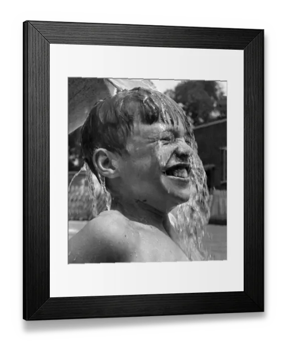 Framed Print : 13 years old David Ranswell of London enjoys every minute as his friends pour buckets of Framed Print : 13 years old David Ranswell of London enjoys every minute as his friends pour buckets of