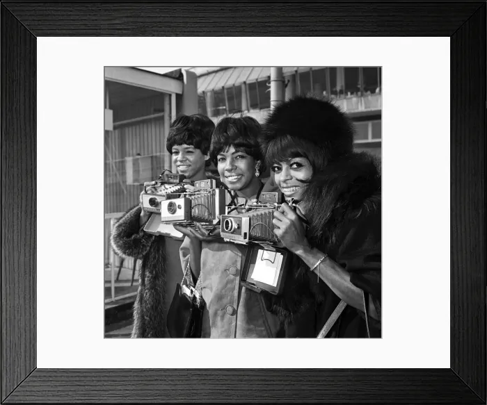 Framed Print : American singing group The Supremes arrive at London airport before taking part in