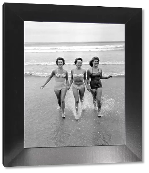 Girls running out of the sea. Newquay, Cornwall. 7th July 1959