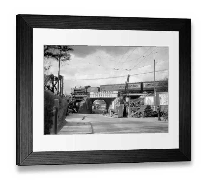 Framed Print : Trolley bus wires frame this Southern Railway passenger train speeding over Malden