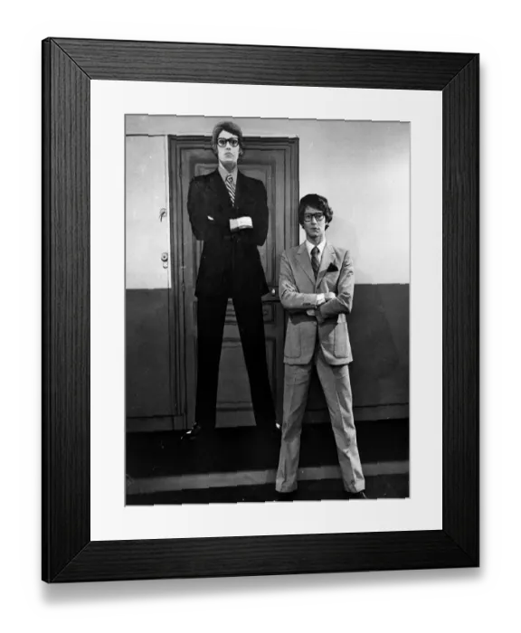 Framed Print : Yves Saint Laurent standing in front of a cardboard cartoon cut out of himself