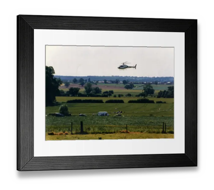 Framed Print : A helicoper hovers over a field at Studley Grange, Warwickshire during the making of TV