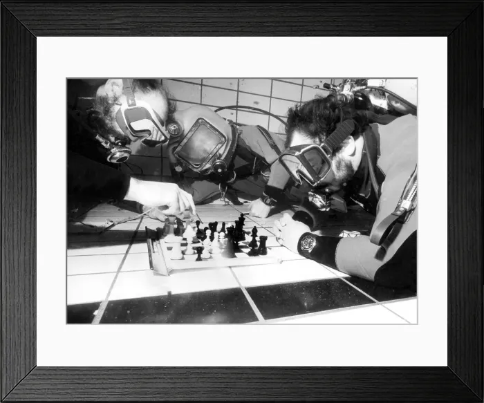 Framed Print : Vince Rice acts as referee for divers Fred Earl and Terry Hart during the underwater