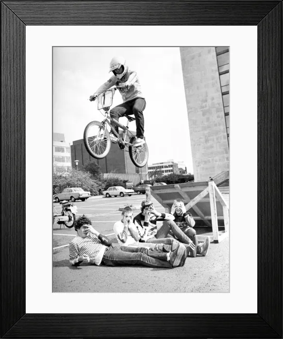 Framed Print : These children can t look while a BMX rider jumps over them in a stunt at Bike Rite Framed Print : These children can t look while a BMX rider jumps over them in a stunt at Bike Rite