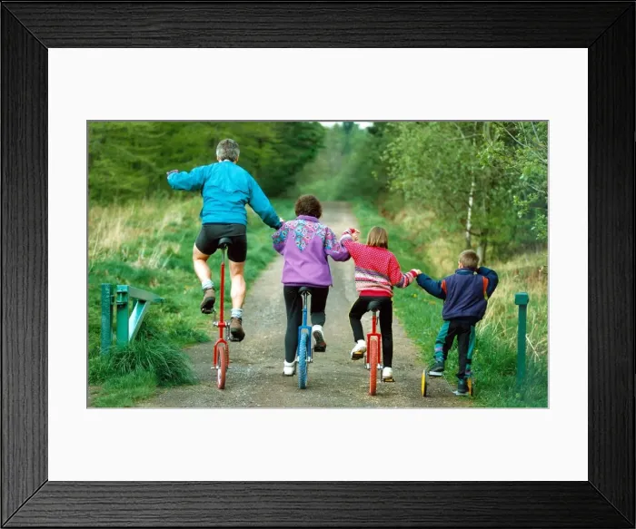 Framed Print : Duncan, Christine, Lisa and Adam on their unicycles near their home in High Spen Framed Print : Duncan, Christine, Lisa and Adam on their unicycles near their home in High Spen