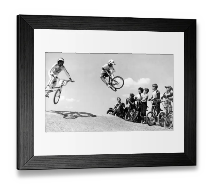 Framed Print : Children racing their BMX bikes over obstacles on a new BMX track Framed Print : Children racing their BMX bikes over obstacles on a new BMX track