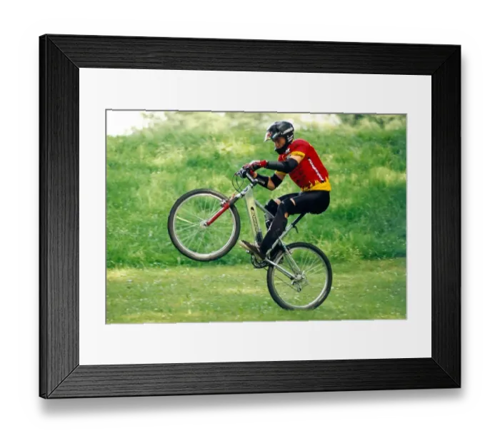 Framed Print : A man performing stunts on his BMX bike Framed Print : A man performing stunts on his BMX bike