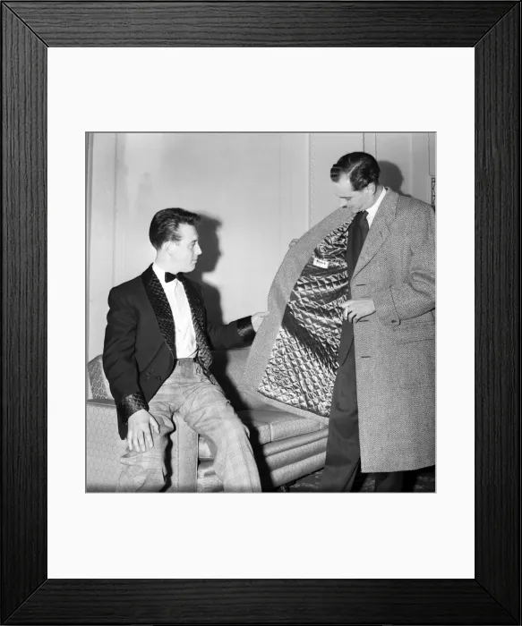Framed Print : Clothing: Fashion: Men. Two of the male mannequins preparing themselves for the first