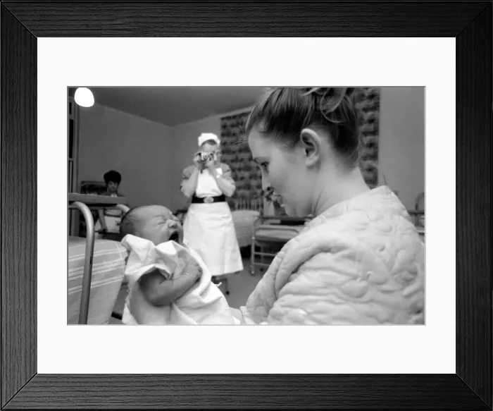 Framed Print : Midwife May Guthrie-Lacy photographs the 287th baby which she has delivered at Lytham