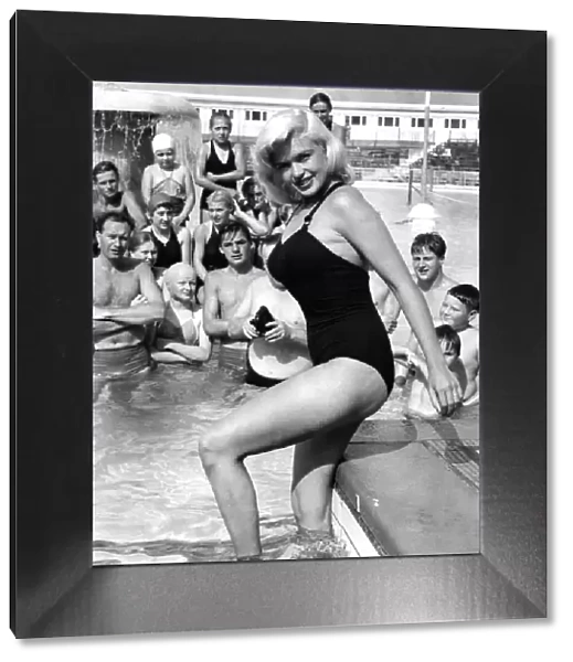 Holidaymakers take pictures of Hollywood superstar Jayne Mansfield at a swimming pool in