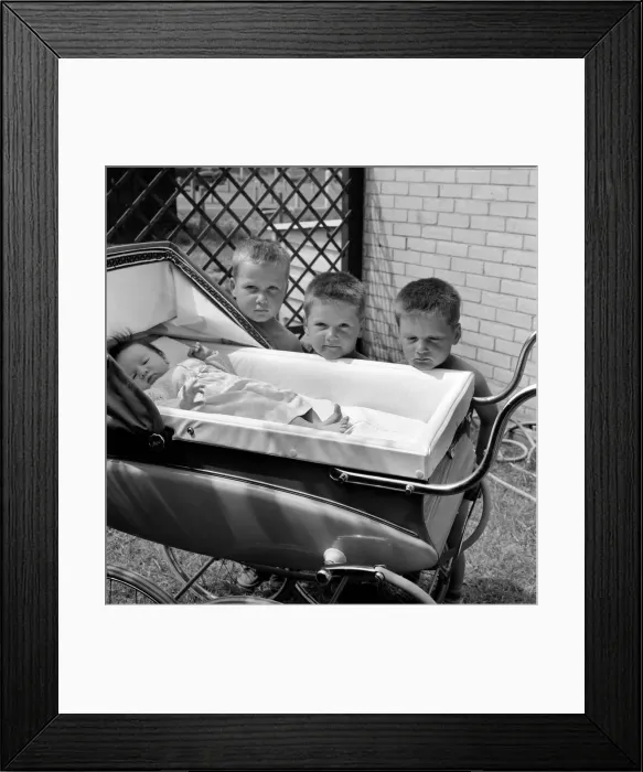 Framed Print : Three gloomy-faced triplet brothers aleaning over the side of a pram in the garden of Framed Print : Three gloomy-faced triplet brothers aleaning over the side of a pram in the garden of