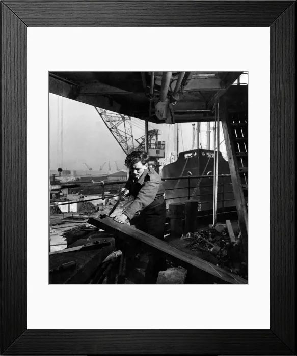 Framed Print : A carpenter makes final repairs to a door being fitted to a cabin on the Karanja