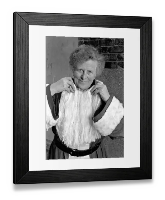 Framed Print : An elderly woman dressed as Santa Claus on her way to an engagement accompanied by Framed Print : An elderly woman dressed as Santa Claus on her way to an engagement accompanied by